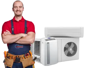 A man wearing red t-shirt, blue pants, stands and has 3 types of air conditioners placed on him.