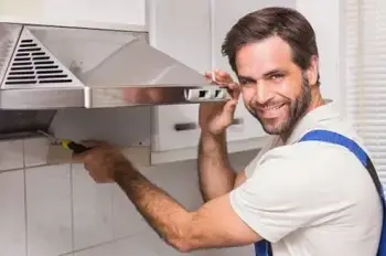 A British man opens a kitchen chimney with a screw driver for repairing